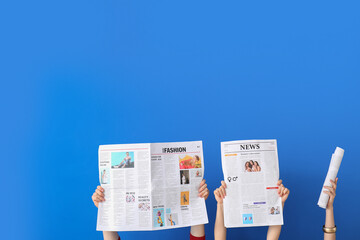 People holding newspapers on blue background