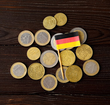 Flag Of Germany And Money On Dark Wooden Background