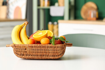 Wicker fruit basket on table in dining room