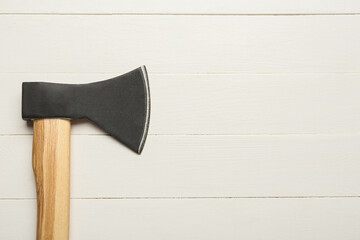 Ax on white wooden background