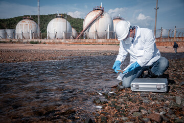 Scientist wearing protective uniform and glove under working water analysis and water quality by...