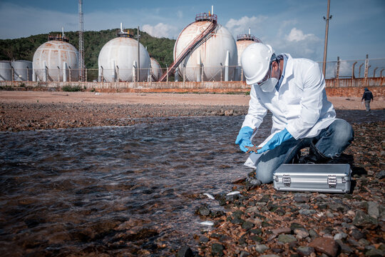 Scientist wearing protective uniform and glove under working water analysis and water quality by get waste water to check case in laboratory is environment pollution problem concept