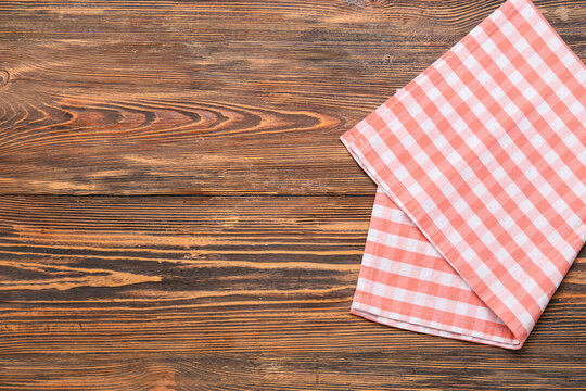 New checkered napkin for picnic on wooden background