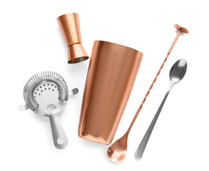 Copper and silver cocktail utensils on white background