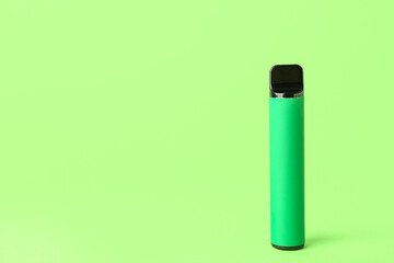 Disposable electronic cigarette on green background