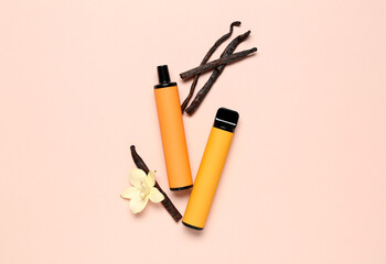 Disposable electronic cigarettes and vanilla flower on pink background