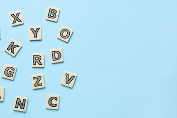 Different letters on blue background. Alphabet concept