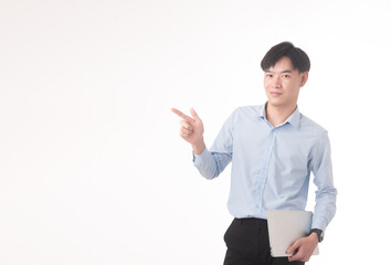 Image of a happy cheery optimistic young unshaved man isolated over beige wall background using laptop computer.