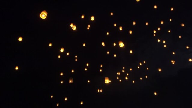 Fire Lanterns Floating up into the sky at night at Loi Krathong Festival Travel Destinations Of Chiang Mai, Thailand