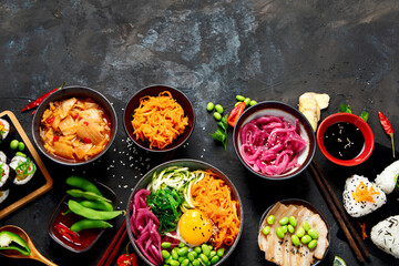 Assortment of Korean food on dark background.