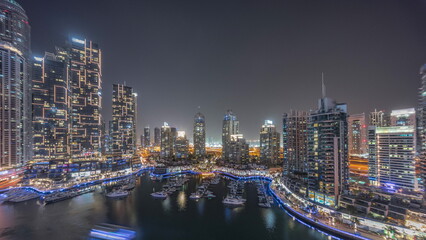 Luxury yacht bay in the city aerial night timelapse in Dubai marina