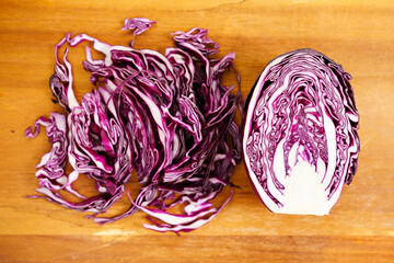 part of red cabbage on wooden board.