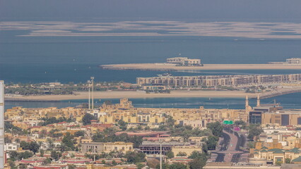 Aerial view of many apartment houses and villas in Dubai city timelapse from skyscraper in downtown