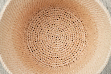 Fototapeta na wymiar natural raffia crochet hat from within view as a textured eco fashion background