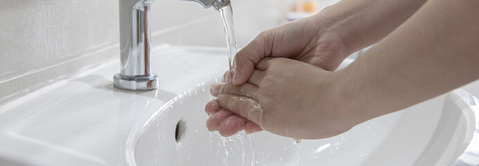 Men are washing their hands in the sinks to clear respiratory bacteria and viruses, sanitation and...