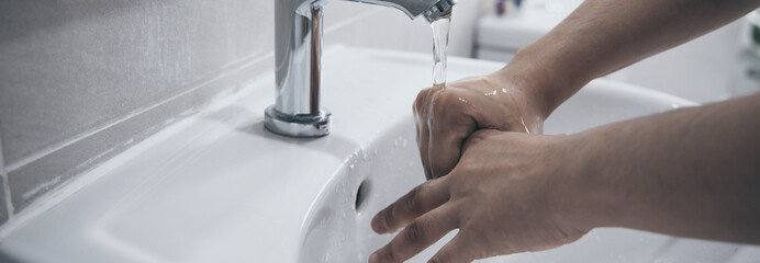 Men are washing their hands in the sinks to clear respiratory bacteria and viruses, sanitation and reduce the spread of COVID-19 that is spread around the world, Hygiene ,Sanitation concept.