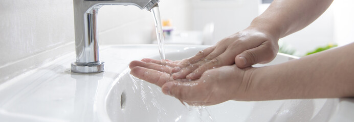 Men are washing their hands in the sinks to clear respiratory bacteria and viruses, sanitation and...