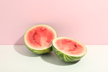 Fresh watermelon halves on two tone background