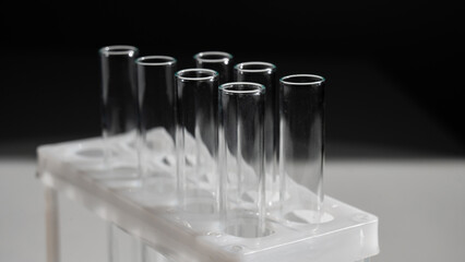 Empty test tubes in a rack on a white background.