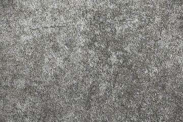 Gray background of decorative plaster with abstract spots. Unusual silver wall texture with beautiful patterns, creative surface background. Dressing coating for building cladding.