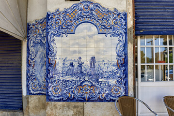 Portuguese Azulejos tiles, depicting typical regional scenes and monument on the facade of Santarem...