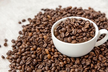 Coffee beans in a white cup