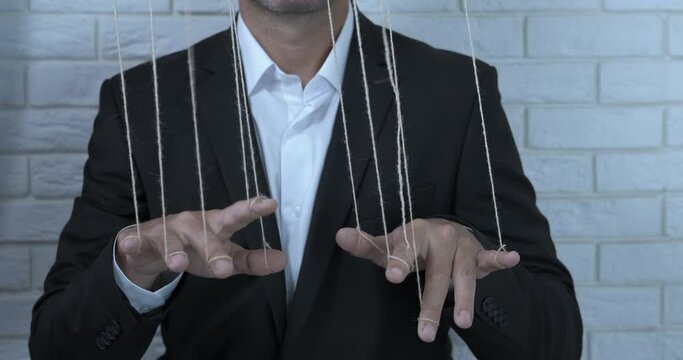 Influenced man with fingers. A view of a business puppet master influence on his office workers.