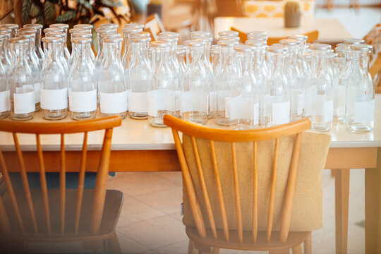 Empty glass bottles on table at cafe