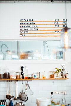 Menu on wall of kitchen at coffee shop