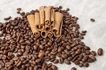 Cinnamon on the background of coffee beans