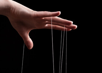 Woman hand with strings on fingers. Victim of domestic violence, slavery. Negative abusive...