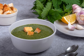 Nettle soup and wild garlic, onion, lemon and crackers. Healthy vegan food