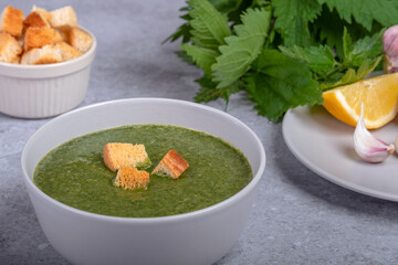 Nettle soup and wild garlic, onion, lemon and crackers. Healthy vegan food