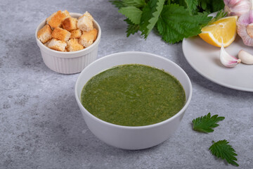 Nettle soup and wild garlic, onion, lemon and crackers. Healthy vegan food