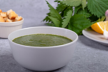 Spring nettle soup and wild, onion, lemon and bread. Healthy vegan food