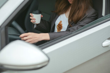 Woman spilled hot coffee on yourself while driving. concept of cleaning stains on clothes