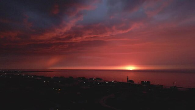 Drone footage zooming out of a sunset on the beach in Gasp&eacute;sie