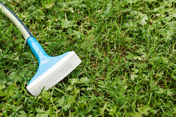 Watering Grass in the Garden in Summer. Hose with Splinkler Tool Save Water during Watering Garden...