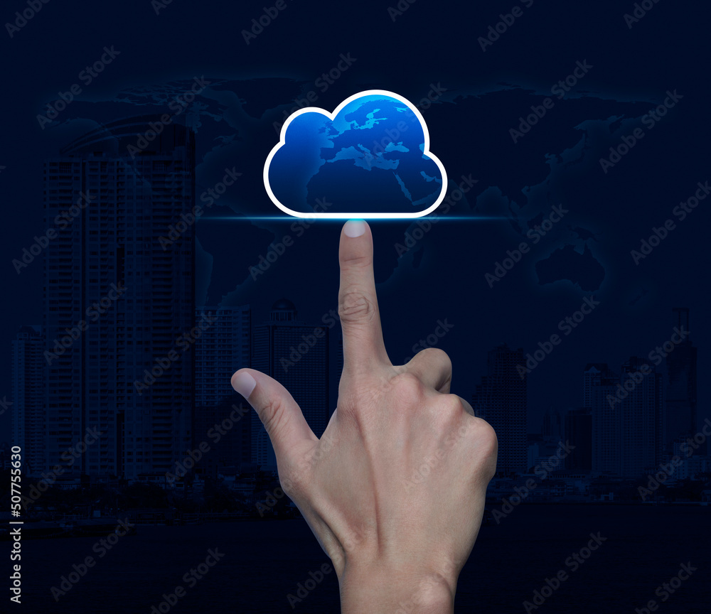 Poster hand click on cloud computing icon with copy space over world map, modern city tower and skyscraper,