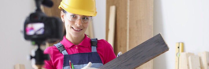 Portrait of professional female worker holding laminate