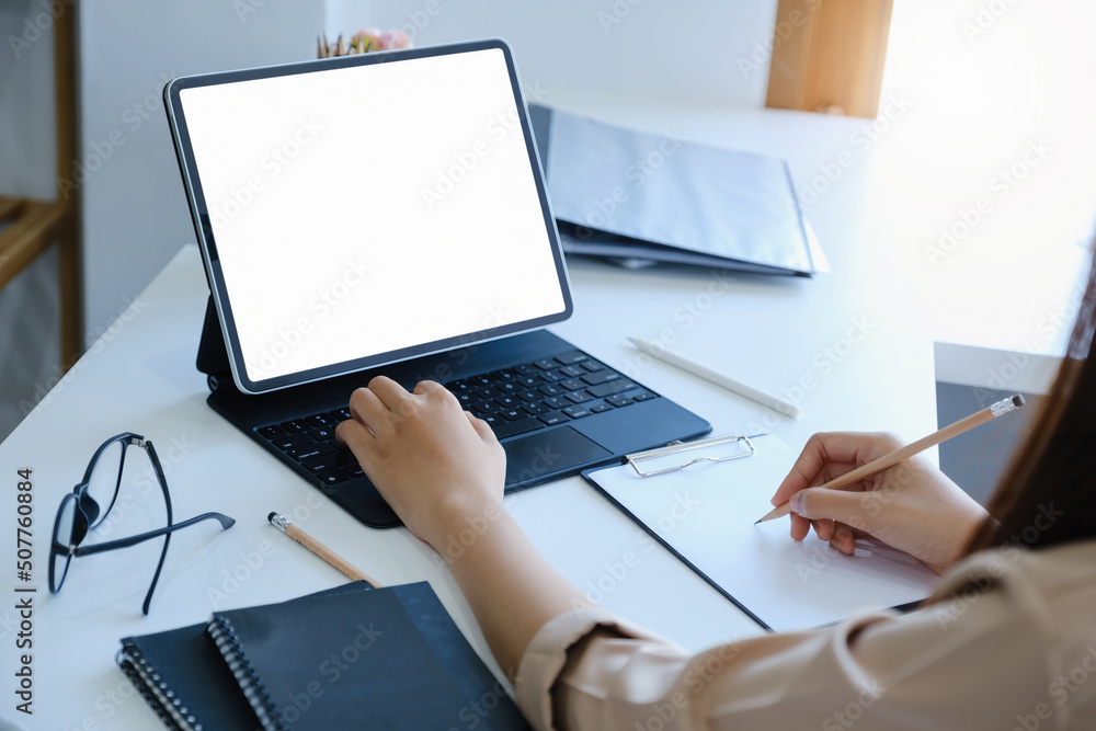 Poster a woman using tablet with a blank white screen. the blank space on the white screen can be used to w
