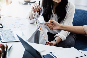 Negotiation, Analysis, Discussion:  Portrait of an Asian woman economist and marketer pointing to a...