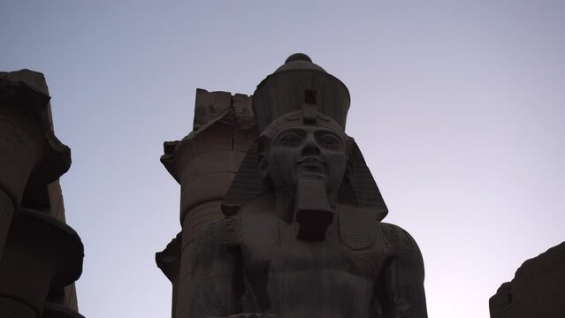 Karnak temple sculture of pharaoh in evening Luxor Egypt sky
