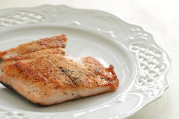 Homemade pan fried Salmon fillet on white plate 