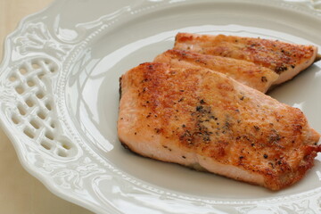 Homemade pan fried Salmon fillet on white plate 