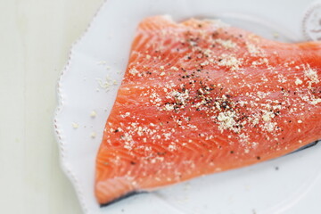 Prepared Salmon fish fillet on white plate for cooking ingredient image
