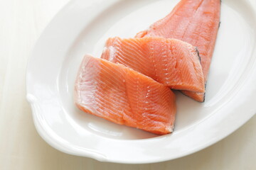 Prepared Salmon fish fillet on white plate for cooking ingredient image