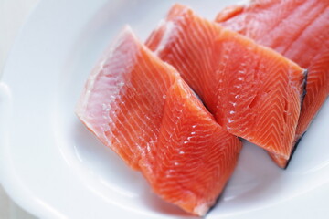 Prepared Salmon fish fillet on white plate for cooking ingredient image