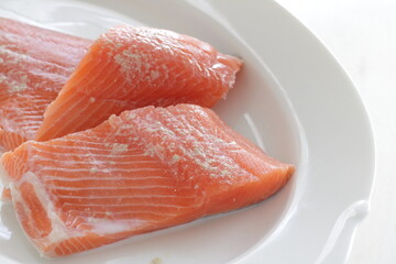 Prepared Salmon fish fillet on white plate for cooking ingredient image
