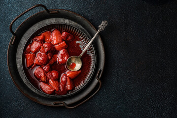 Fresh strawberry sauce on a plate on a dark background - Powered by Adobe